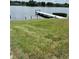 A wooden dock sits on the lake, perfect for fishing or enjoying the natural surroundings at 1550 11Th Ne St # A2, Winter Haven, FL 33881