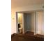 Hallway showcasing entrance to bathroom and bedroom, next to closet with white doors at 1550 11Th Ne St # A2, Winter Haven, FL 33881