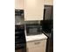Picture featuring a microwave sitting on top of a kitchen countertop with matching cabinets at 1550 11Th Ne St # A2, Winter Haven, FL 33881