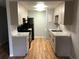 Kitchen with updated cabinets, countertops, backsplash, and new laminate flooring at 1550 11Th Ne St # A2, Winter Haven, FL 33881