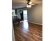 Bright living room featuring sliding doors leading to the patio, ceiling fan, and kitchen area at 1550 11Th Ne St # A2, Winter Haven, FL 33881