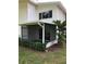 A screened patio is surrounded by manicured greenery and a small palm tree at 1550 11Th Ne St # A2, Winter Haven, FL 33881