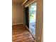 Picture showcasing the sliding doors to screened patio with seating and a view of lawn at 1550 11Th Ne St # A2, Winter Haven, FL 33881