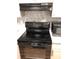 Close up of the stove and microwave with a stylish backsplash at 1550 11Th Ne St # A2, Winter Haven, FL 33881