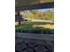 A view from the screened-in porch looks out onto a green lawn and the street beyond at 1550 11Th Ne St # A2, Winter Haven, FL 33881