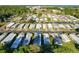 Aerial of community offering waterfront homes and numerous amenities, set amongst mature trees and landscaping at 167 Bonnie Dr, Auburndale, FL 33823