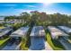 Aerial view of homes with carports in a community with canals, landscaping, and trees at 167 Bonnie Dr, Auburndale, FL 33823