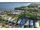 Aerial view of a lakeside community with well-maintained homes and lush trees at 167 Bonnie Dr, Auburndale, FL 33823
