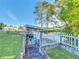 Waterfront property boasts private boat dock with lift access, lush lawn, and charming picket fence at 167 Bonnie Dr, Auburndale, FL 33823