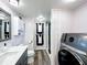 Updated bathroom featuring a sleek vanity, shower, and modern washer/dryer unit at 167 Bonnie Dr, Auburndale, FL 33823