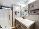 Stylized bathroom featuring a walk-in shower, modern vanity, and unique wood cabinetry at 167 Bonnie Dr, Auburndale, FL 33823