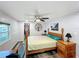 Cozy bedroom featuring a wooden bed frame, ceiling fan, and closet space at 167 Bonnie Dr, Auburndale, FL 33823