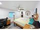Bedroom with wooden bed, ceiling fan, and closet in a home with light-colored walls and wood-look floors at 167 Bonnie Dr, Auburndale, FL 33823