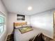 Bedroom with bed, wooden headboard, neutral walls, and natural light from the window at 167 Bonnie Dr, Auburndale, FL 33823