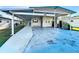 Spacious carport with lattice trim, offering covered parking and protection from the elements at 167 Bonnie Dr, Auburndale, FL 33823