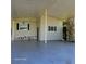Spacious carport featuring ample parking space, green siding, white lattice decoration, and easy access to the house at 167 Bonnie Dr, Auburndale, FL 33823