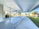 Wide carport with large concrete pad, overhead structure, and view of neighborhood homes at 167 Bonnie Dr, Auburndale, FL 33823