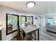 Bright dining area with wood table and seating, with views of the screened porch at 167 Bonnie Dr, Auburndale, FL 33823