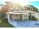 Inviting single-story home with a covered carport and a well-manicured front yard at 167 Bonnie Dr, Auburndale, FL 33823