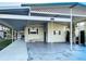 Single-story home featuring covered parking and a well-maintained exterior with decorative lattice at 167 Bonnie Dr, Auburndale, FL 33823