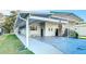 Charming exterior elevation with covered parking and well-manicured lawn at 167 Bonnie Dr, Auburndale, FL 33823