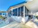 Well maintained exterior view of home with brick stairs and adjacent walkway with outdoor grill at 167 Bonnie Dr, Auburndale, FL 33823