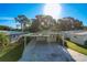 Charming home with a spacious carport and well-maintained landscaping under a clear blue sky at 167 Bonnie Dr, Auburndale, FL 33823