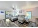 Inviting living room featuring wood-look floors, ceiling fan, and a comfortable gray sectional sofa at 167 Bonnie Dr, Auburndale, FL 33823