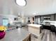 Open floor plan showing the kitchen and living room combo with modern appliances and comfortable gray furnishings at 167 Bonnie Dr, Auburndale, FL 33823