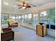Bright sunroom with lots of natural light, a ceiling fan, and views of the waterfront property at 167 Bonnie Dr, Auburndale, FL 33823