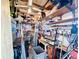 Organized workshop area featuring ample shelving, tools, and a ceiling fan for ventilation at 167 Bonnie Dr, Auburndale, FL 33823