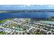 Aerial view of a community with houses, a large lake, and lush green landscaping at 169 Summershore Dr, Auburndale, FL 33823