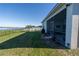 Picturesque backyard with view of lake, screened in porch, and well-manicured lawn at 169 Summershore Dr, Auburndale, FL 33823