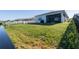 Large backyard with lush green grass, modern fence, and ample space for outdoor activities at 169 Summershore Dr, Auburndale, FL 33823