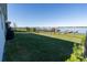 Spacious backyard with lush green lawn and waterfront views, complete with dock and boat lift at 169 Summershore Dr, Auburndale, FL 33823