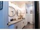 Bathroom featuring double sinks, granite countertops, modern mirrors, and stylish wall art at 169 Summershore Dr, Auburndale, FL 33823