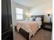 Cozy bedroom featuring a comfortable bed with stylish bedding and a bedside table with lamp at 169 Summershore Dr, Auburndale, FL 33823