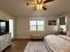 This bedroom features a ceiling fan, wood floors, a water view and a decorative rug at 169 Summershore Dr, Auburndale, FL 33823