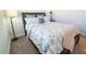 Bright bedroom showcasing a plush bed with floral bedding, a bedside table and modern lamp at 169 Summershore Dr, Auburndale, FL 33823