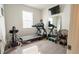 Bright, well-lit exercise room with treadmill, rowing machine, and weights for a convenient home workout space at 169 Summershore Dr, Auburndale, FL 33823