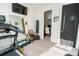 Exercise room featuring a treadmill, weights, punching bag, and view into the office at 169 Summershore Dr, Auburndale, FL 33823