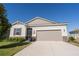 Charming single-Gathering home featuring a well-manicured lawn and a two-car garage at 169 Summershore Dr, Auburndale, FL 33823