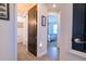 View of the hallway leading to the bathroom and bedroom with wood-like tile flooring at 169 Summershore Dr, Auburndale, FL 33823