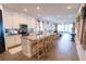 Open kitchen layout featuring a large island with bar stools, stainless steel appliances, and modern finishes, great for entertaining at 169 Summershore Dr, Auburndale, FL 33823