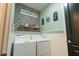 Laundry room with front load washer and dryer, wallpaper, and decorative signs at 169 Summershore Dr, Auburndale, FL 33823