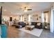 Spacious living room with modern furniture, tile flooring, and open layout, flowing seamlessly into the kitchen and dining area at 169 Summershore Dr, Auburndale, FL 33823