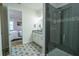 En Suite bathroom featuring stylish patterned tile, a frameless shower, and a double vanity at 169 Summershore Dr, Auburndale, FL 33823