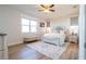 Cozy main bedroom featuring two windows, a ceiling fan and stylish decor at 169 Summershore Dr, Auburndale, FL 33823