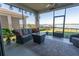 Relaxing screened patio with stylish furniture and scenic waterfront views, ideal for enjoying the outdoors at 169 Summershore Dr, Auburndale, FL 33823