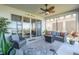 Inviting screened patio with comfortable seating and ceiling fan, perfect for outdoor relaxation and lake views at 169 Summershore Dr, Auburndale, FL 33823